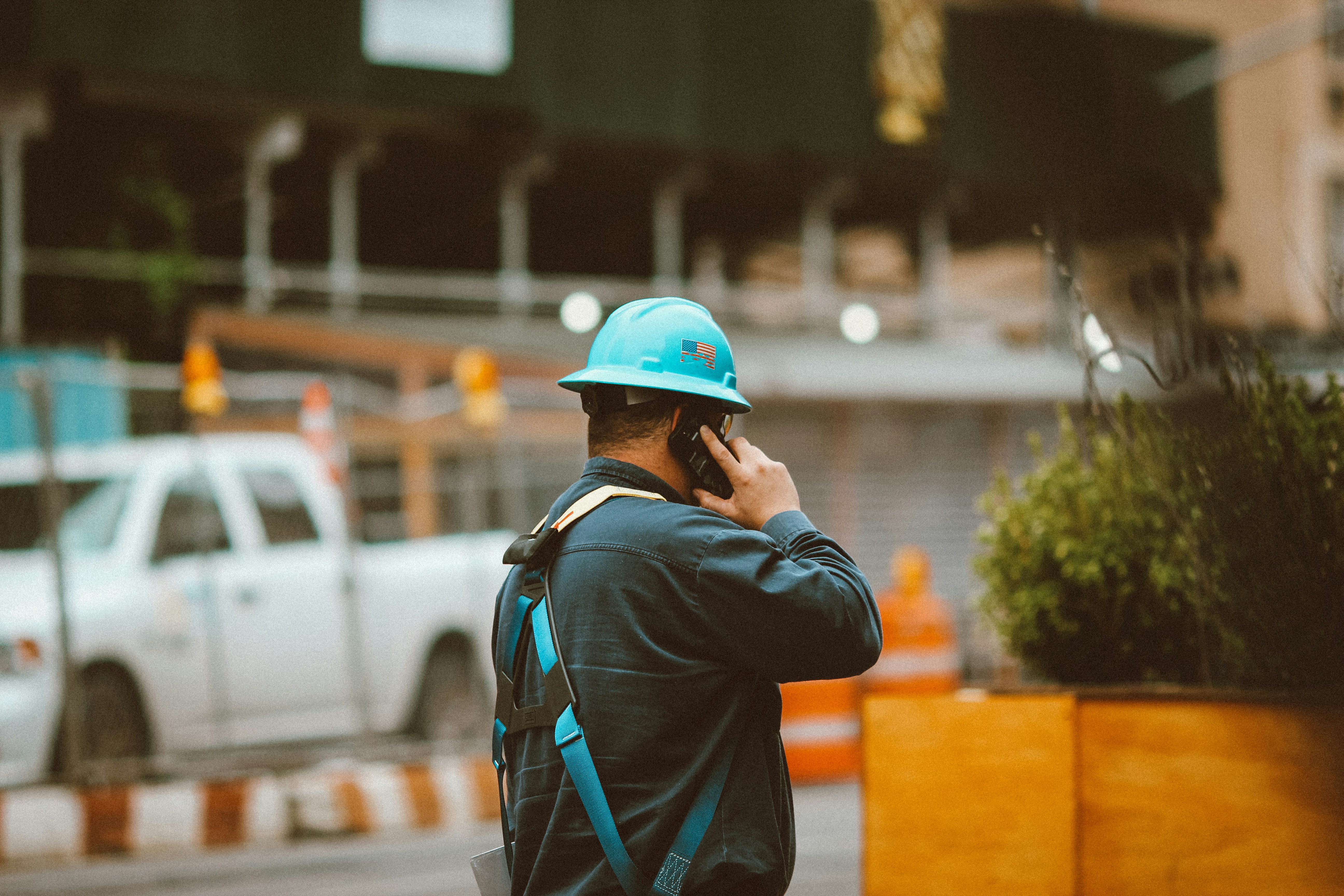 Trades contractor talking on the phone at a job site